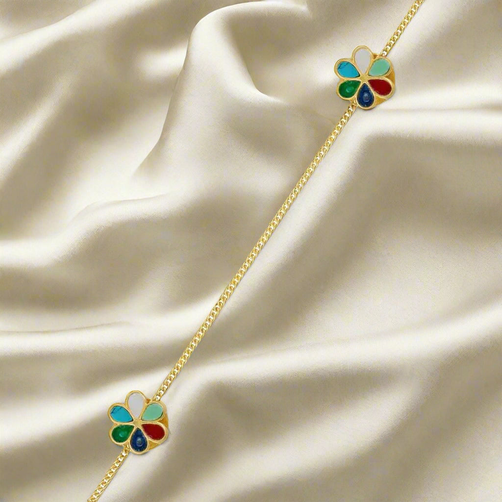 Gold necklace with colorful flower-shaped pendants on a white background